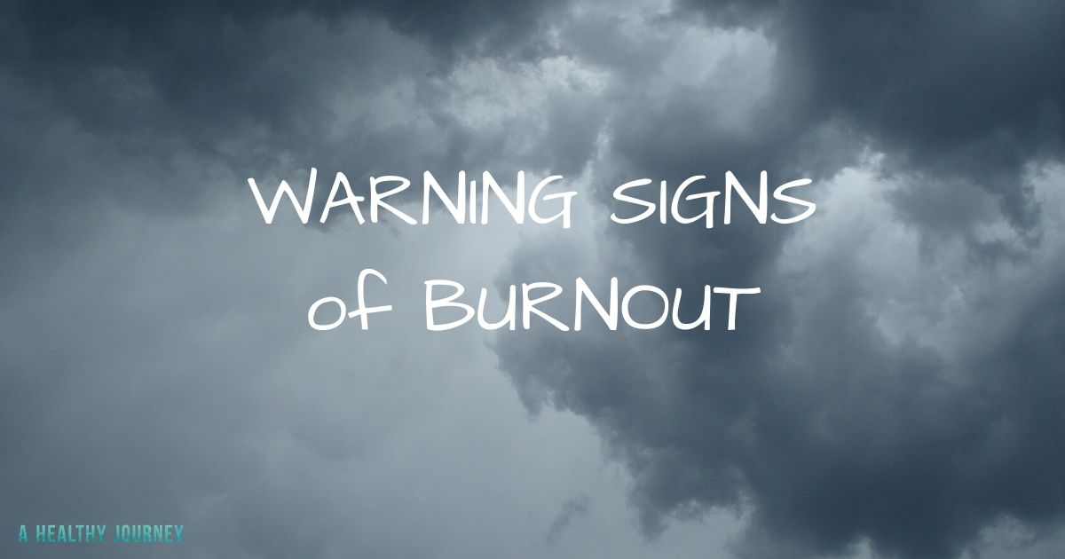 Background of clouds with text: Warning Signs of Burnout